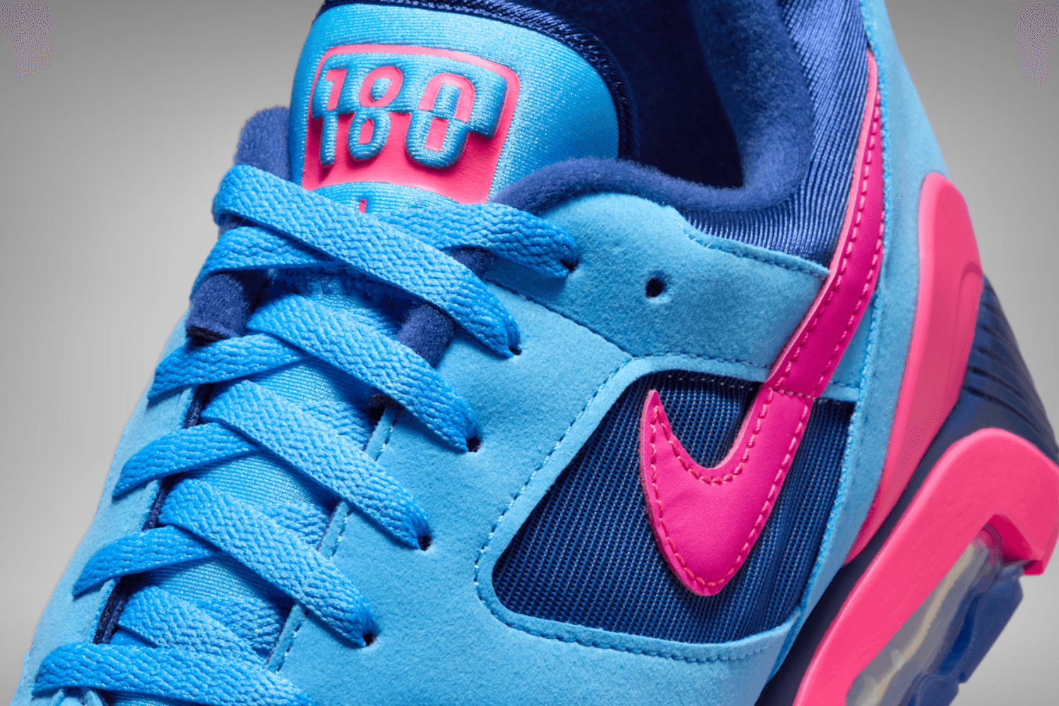 The Nike Air 180 appears in a 'University Blue/Hyper Pink' colorway