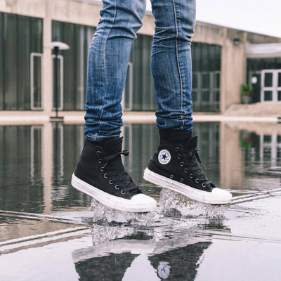 High black Converse on feet