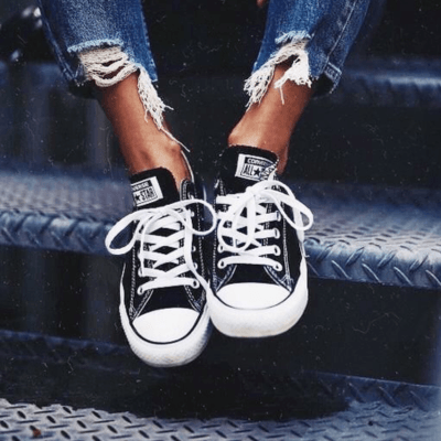 Low top black Converse on feet