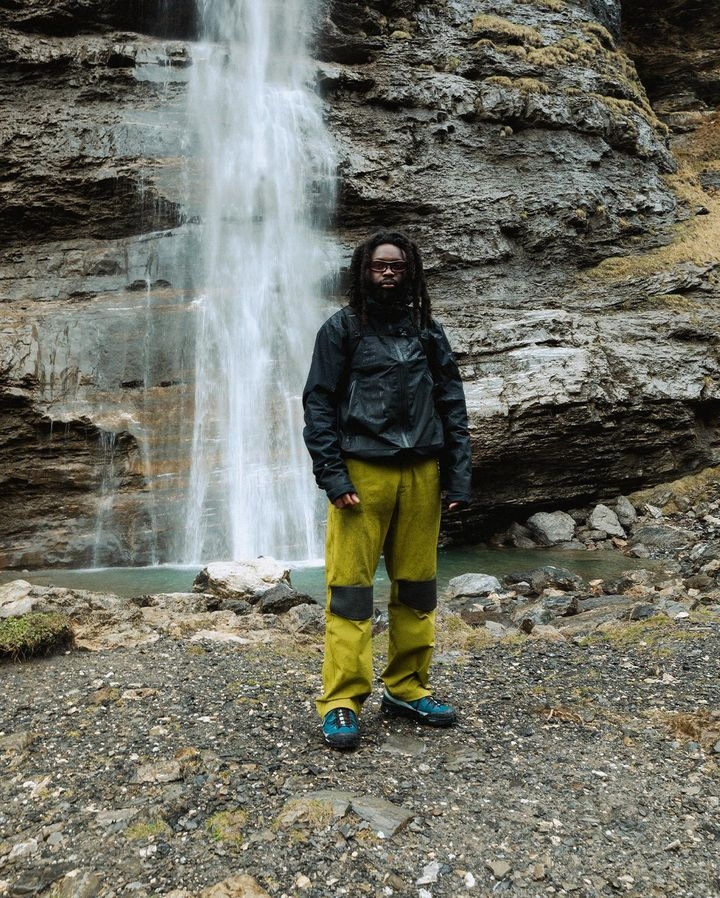 Men standing in front of a waterfall wearing Salomon