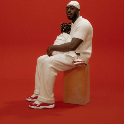 Men wearing AJ 11 sitting while holding a kid